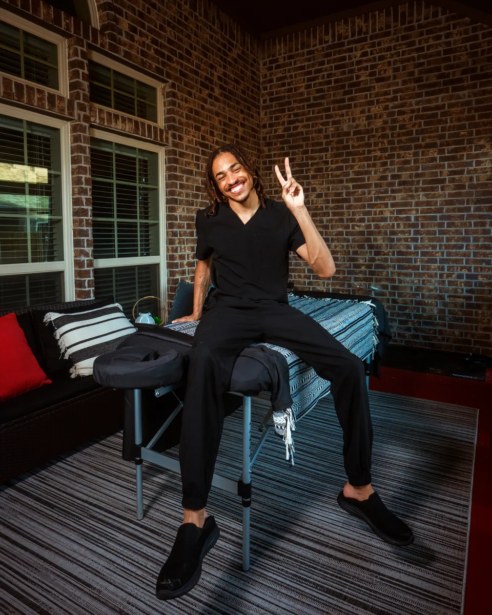 Cam Reid smiling in professional massage attire